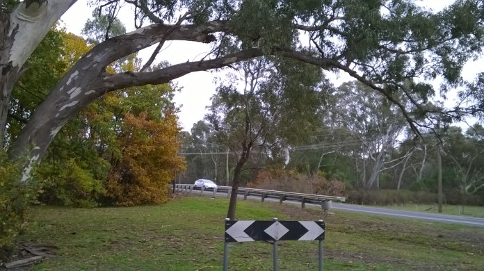 at the end of the service road, the footbridge is on the left, unseen